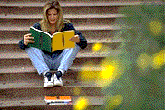Student reading on steps
