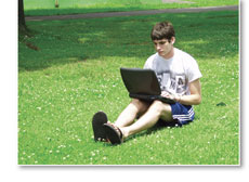 Student using laptop outdoors
